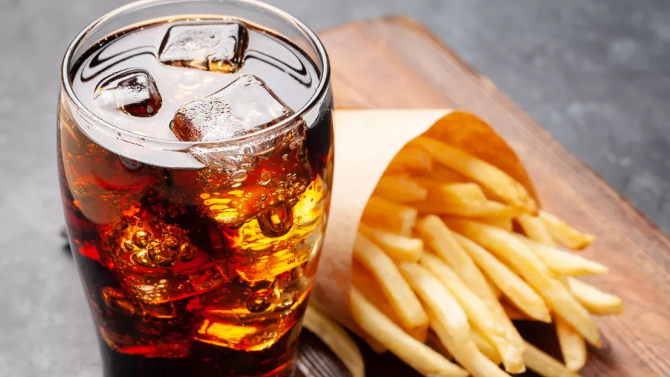 Photo of soft drink and french fries.