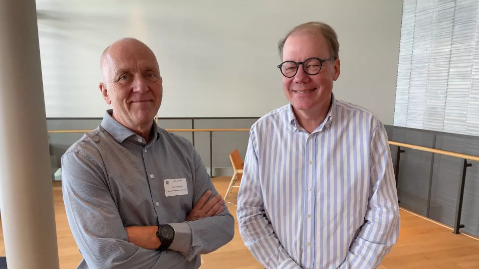 Photo of two researchers at a conference.