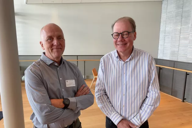 Photo of two researchers at a conference.