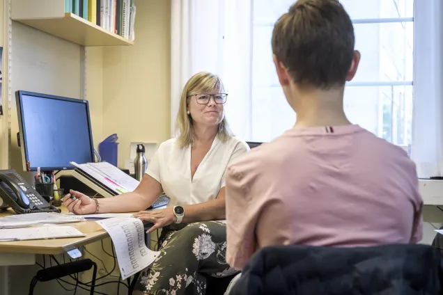 Photograph of a research nurse and study participant.
