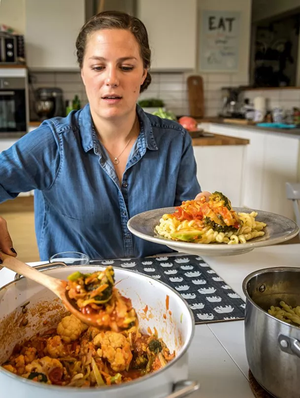 Louise Brunkwall puts food on a plate